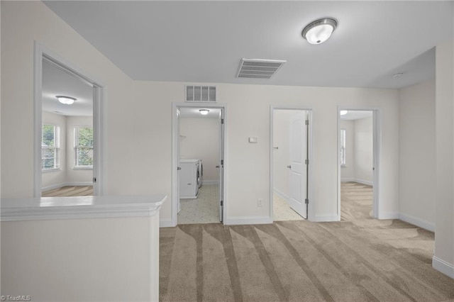 unfurnished bedroom with carpet floors, baseboards, and a walk in closet