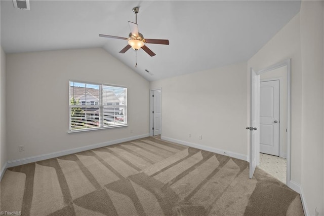 spare room with ceiling fan, carpet, vaulted ceiling, and baseboards