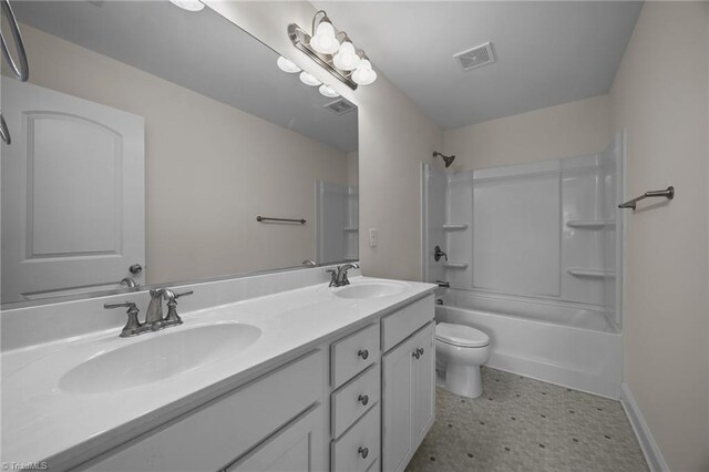 bathroom with toilet, double vanity, tub / shower combination, tile patterned floors, and baseboards