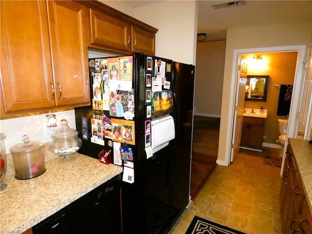 149 Pinewood Ln Unit 104, Bermuda Run, NC 27006 - kitchen featuring freestanding refrigerator, brown cabinets, and baseboards