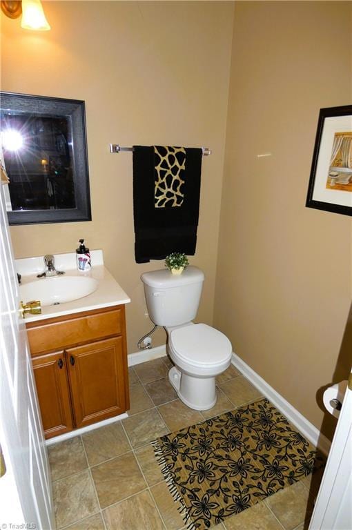 149 Pinewood Ln Unit 104, Bermuda Run, NC 27006 - bathroom with toilet, vanity, and baseboards