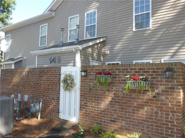 149 Pinewood Ln Unit 104, Bermuda Run, NC 27006 - view of home's exterior featuring central air condition unit and a gate