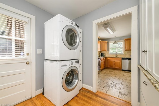 1134 W End Blvd, Winston-Salem, NC 27101 - laundry area featuring stacked washing machine and dryer and stone tile floors
