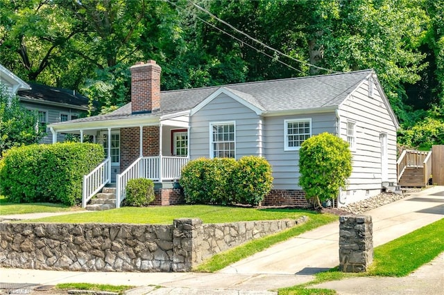 1134 W End Blvd, Winston-Salem, NC 27101 - ranch-style house with a chimney, a porch, a shingled roof, and a front lawn
