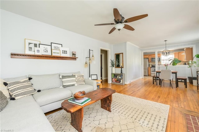 1134 W End Blvd, Winston-Salem, NC 27101 - living room featuring a ceiling fan, light wood-style flooring, and a chandelier