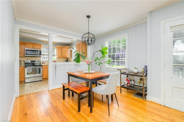 1134 W End Blvd, Winston-Salem, NC 27101 - dining room featuring light wood-style flooring, crown molding, and a chandelier