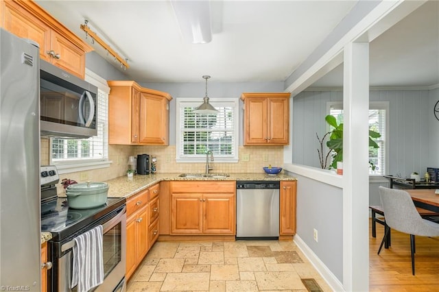 1134 W End Blvd, Winston-Salem, NC 27101 - kitchen with appliances with stainless steel finishes, backsplash, light stone counters, and decorative light fixtures