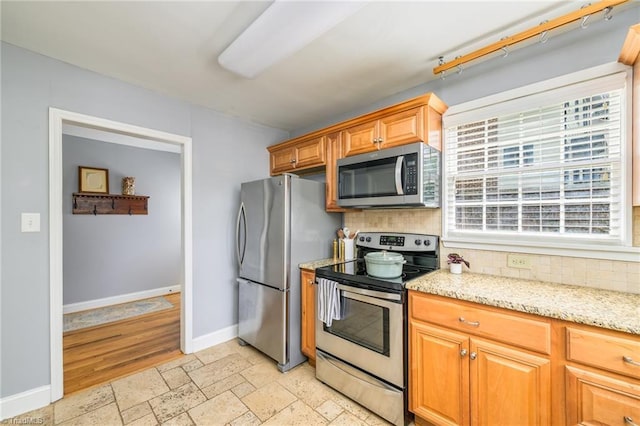1134 W End Blvd, Winston-Salem, NC 27101 - kitchen with stainless steel appliances, tasteful backsplash, light stone counters, and stone tile flooring