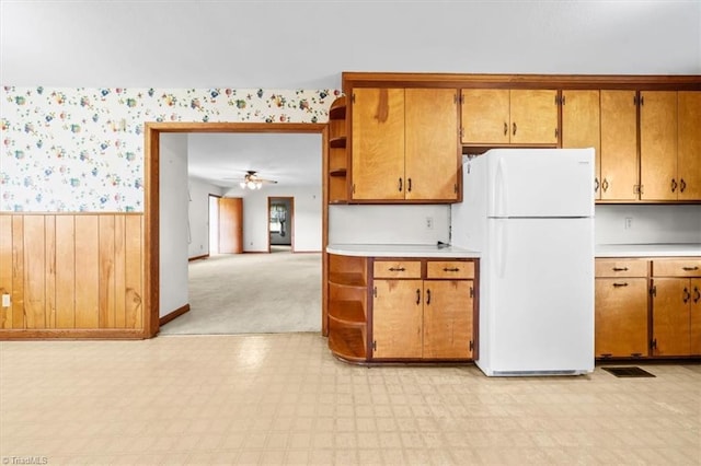 6277 Bennett Rd, Seagrove, NC 27341 - kitchen featuring freestanding refrigerator, wallpapered walls, light floors, light countertops, and a wainscoted wall