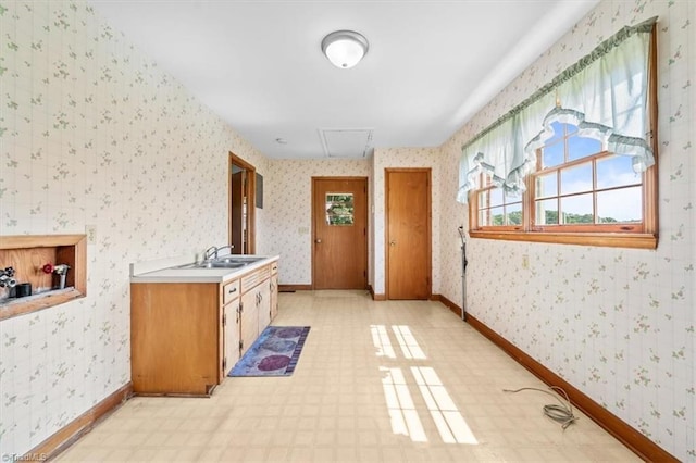 6277 Bennett Rd, Seagrove, NC 27341 - kitchen featuring wallpapered walls, light flooring, light countertops, and baseboards