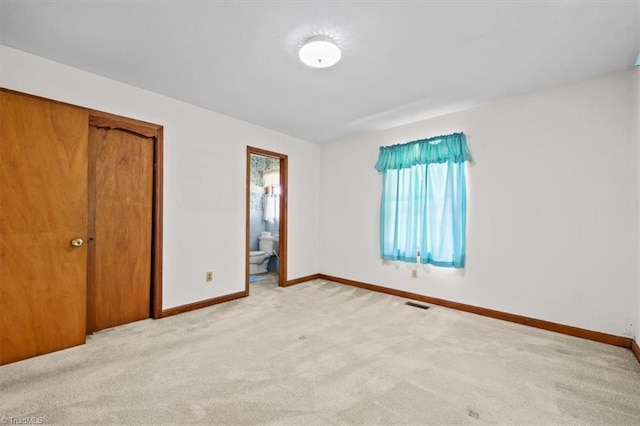 6277 Bennett Rd, Seagrove, NC 27341 - unfurnished bedroom featuring baseboards, light colored carpet, a closet, and ensuite bathroom