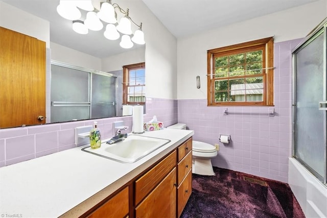 6277 Bennett Rd, Seagrove, NC 27341 - full bathroom with vanity, tile walls, toilet, plenty of natural light, and a chandelier
