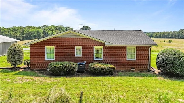 6277 Bennett Rd, Seagrove, NC 27341 - view of side of home featuring central AC unit, a lawn, brick siding, and roof with shingles