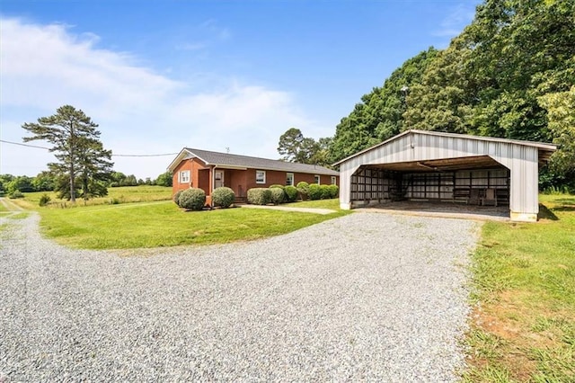 6277 Bennett Rd, Seagrove, NC 27341 - view of front of home featuring gravel driveway, a detached carport, a front lawn, and an outbuilding