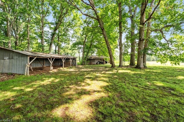 6277 Bennett Rd, Seagrove, NC 27341 - view of grassy yard with a pole building and an outdoor structure
