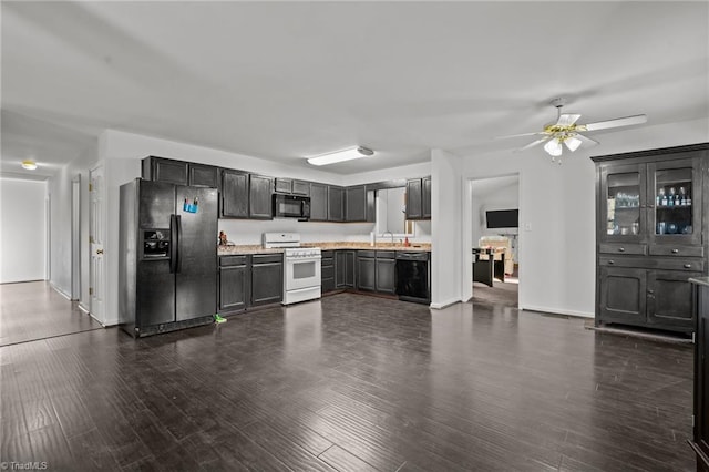 kitchen featuring black appliances, ceiling fan, dark hardwood / wood-style flooring, and sink