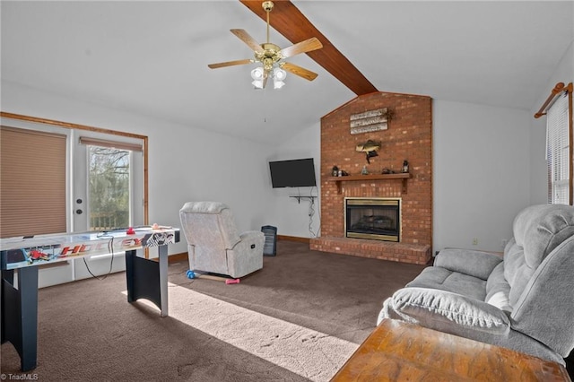 carpeted living room featuring a brick fireplace, vaulted ceiling with beams, and ceiling fan