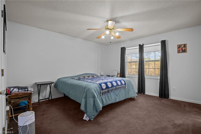 carpeted bedroom with ceiling fan and a textured ceiling