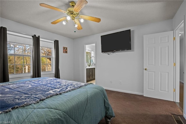 bedroom with ceiling fan, carpet floors, ensuite bathroom, and a textured ceiling