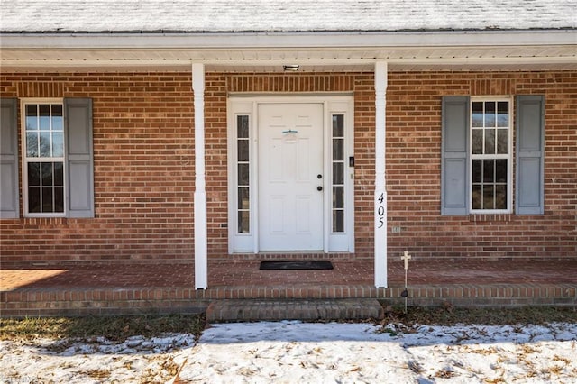 view of snow covered property entrance