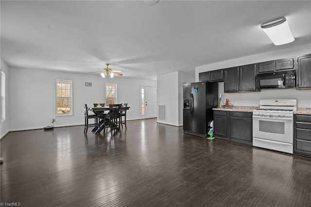 kitchen with black appliances, ceiling fan, and dark hardwood / wood-style flooring