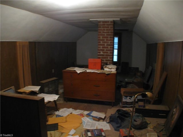 bonus room with lofted ceiling, decorative columns, and light wood-style flooring