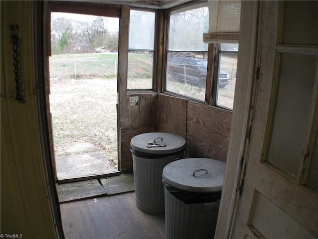 bathroom with wood-type flooring and a healthy amount of sunlight