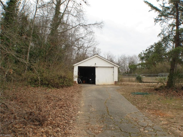 detached garage featuring fence