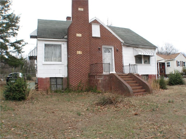 view of front of home featuring a chimney