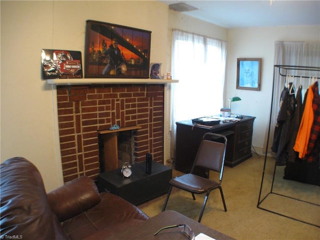 carpeted living area featuring a brick fireplace