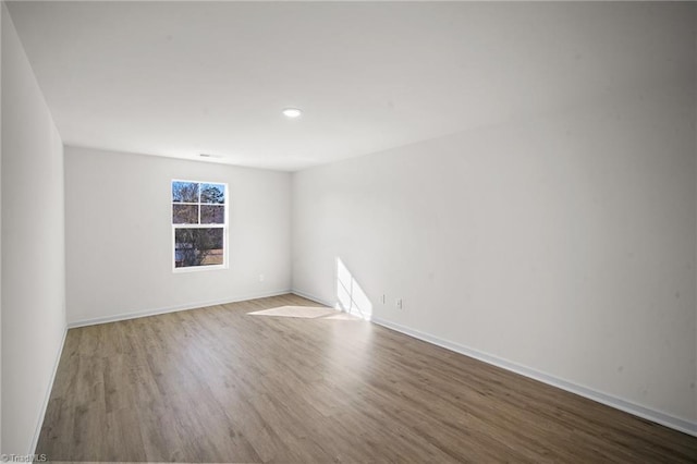 unfurnished room with hardwood / wood-style floors