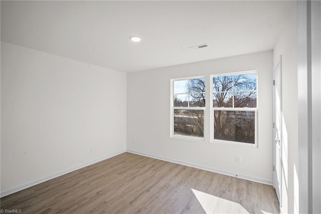 unfurnished room with light hardwood / wood-style floors