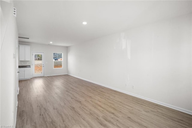 unfurnished living room with light hardwood / wood-style flooring