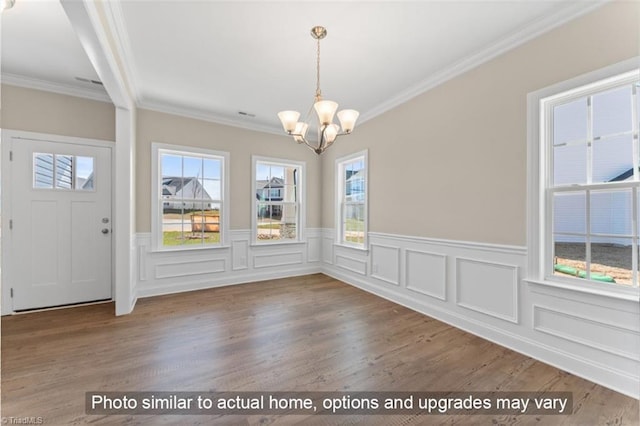 4090 Stallion St Lot 74, High Point, NC 27262 - unfurnished dining area with a chandelier, a wainscoted wall, wood finished floors, crown molding, and a decorative wall
