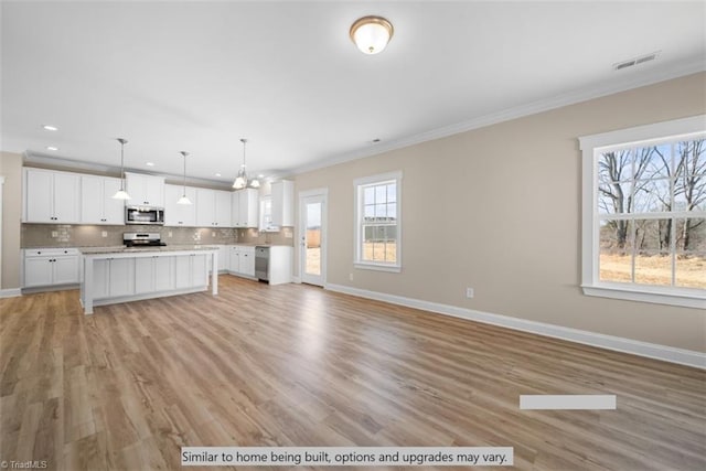 4090 Stallion St Lot 74, High Point, NC 27262 - unfurnished living room featuring crown molding, plenty of natural light, recessed lighting, light wood finished floors, and a chandelier