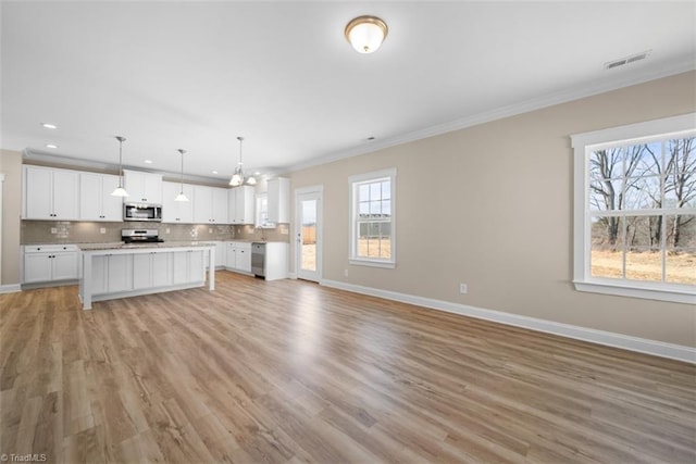 4090 Stallion St Lot 74, High Point, NC 27262 - kitchen featuring stainless steel appliances, open floor plan, crown molding, white cabinets, and tasteful backsplash