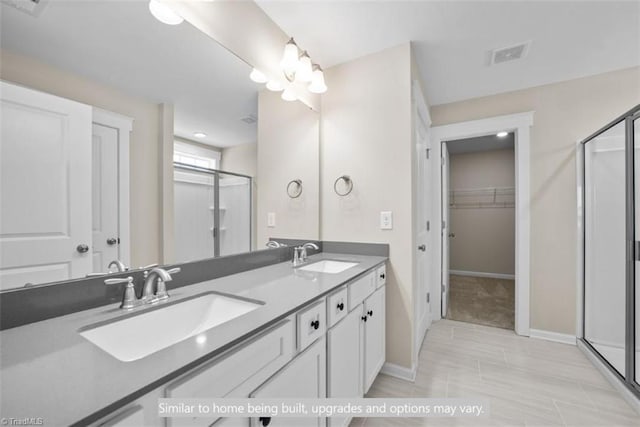4090 Stallion St Lot 74, High Point, NC 27262 - full bathroom with a shower stall, double vanity, a walk in closet, and tile patterned floors