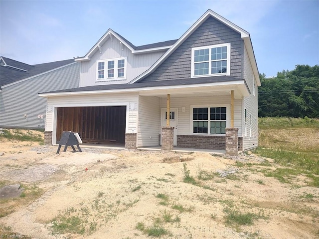 4090 Stallion St Lot 74, High Point, NC 27262 - view of front of house featuring brick siding, a porch, and an attached garage