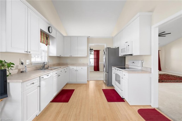 kitchen featuring lofted ceiling, white cabinets, sink, light hardwood / wood-style flooring, and white appliances