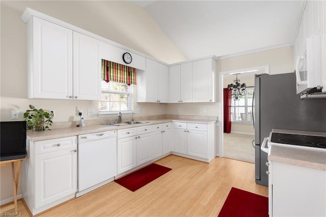 kitchen with light hardwood / wood-style floors, white cabinetry, sink, white appliances, and lofted ceiling