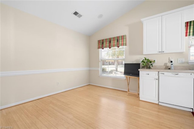 kitchen featuring white dishwasher, white cabinets, light wood-type flooring, and vaulted ceiling