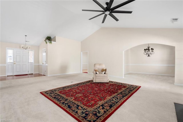 living room with carpet flooring, ceiling fan with notable chandelier, and lofted ceiling