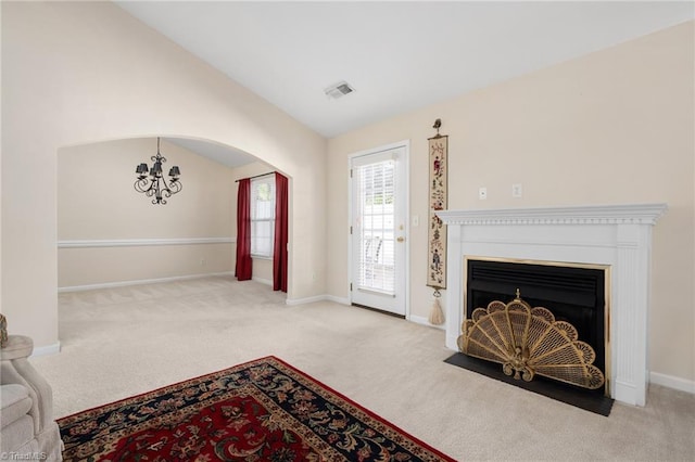 carpeted living room with vaulted ceiling