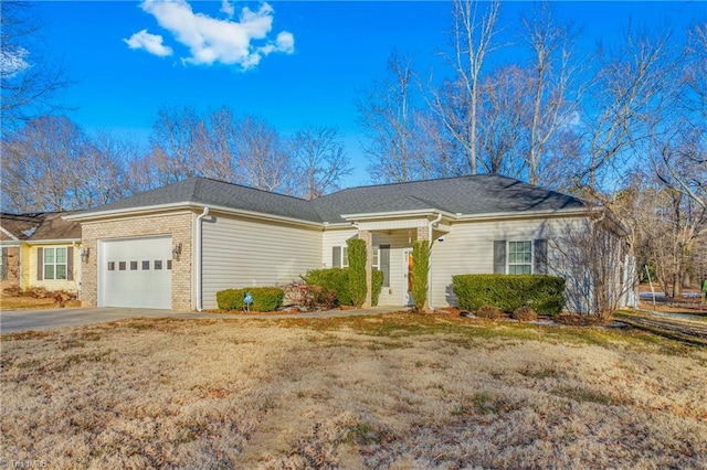 single story home featuring a front lawn and a garage