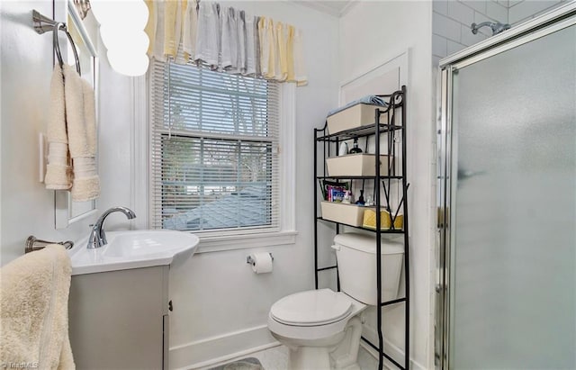 bathroom with vanity, a shower with door, and toilet