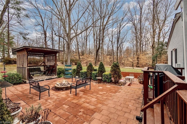 view of patio featuring a gazebo and a fire pit