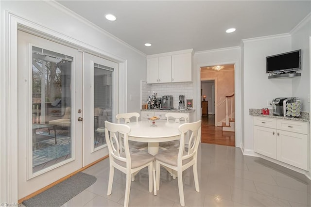 dining space featuring ornamental molding, french doors, and light tile patterned flooring