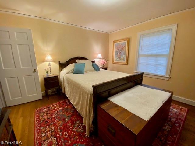 305 W Avondale Dr, Greensboro, NC 27403 - bedroom featuring wood finished floors and baseboards