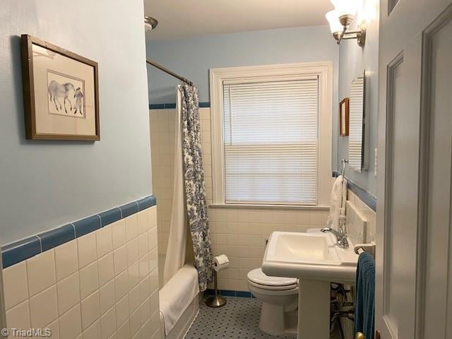 305 W Avondale Dr, Greensboro, NC 27403 - bathroom featuring tile walls, toilet, shower / bath combination with curtain, and wainscoting