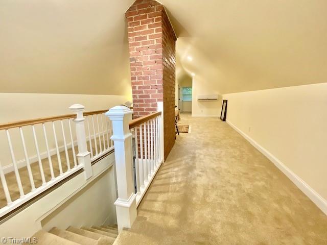 305 W Avondale Dr, Greensboro, NC 27403 - hallway featuring lofted ceiling, an upstairs landing, carpet floors, and baseboards